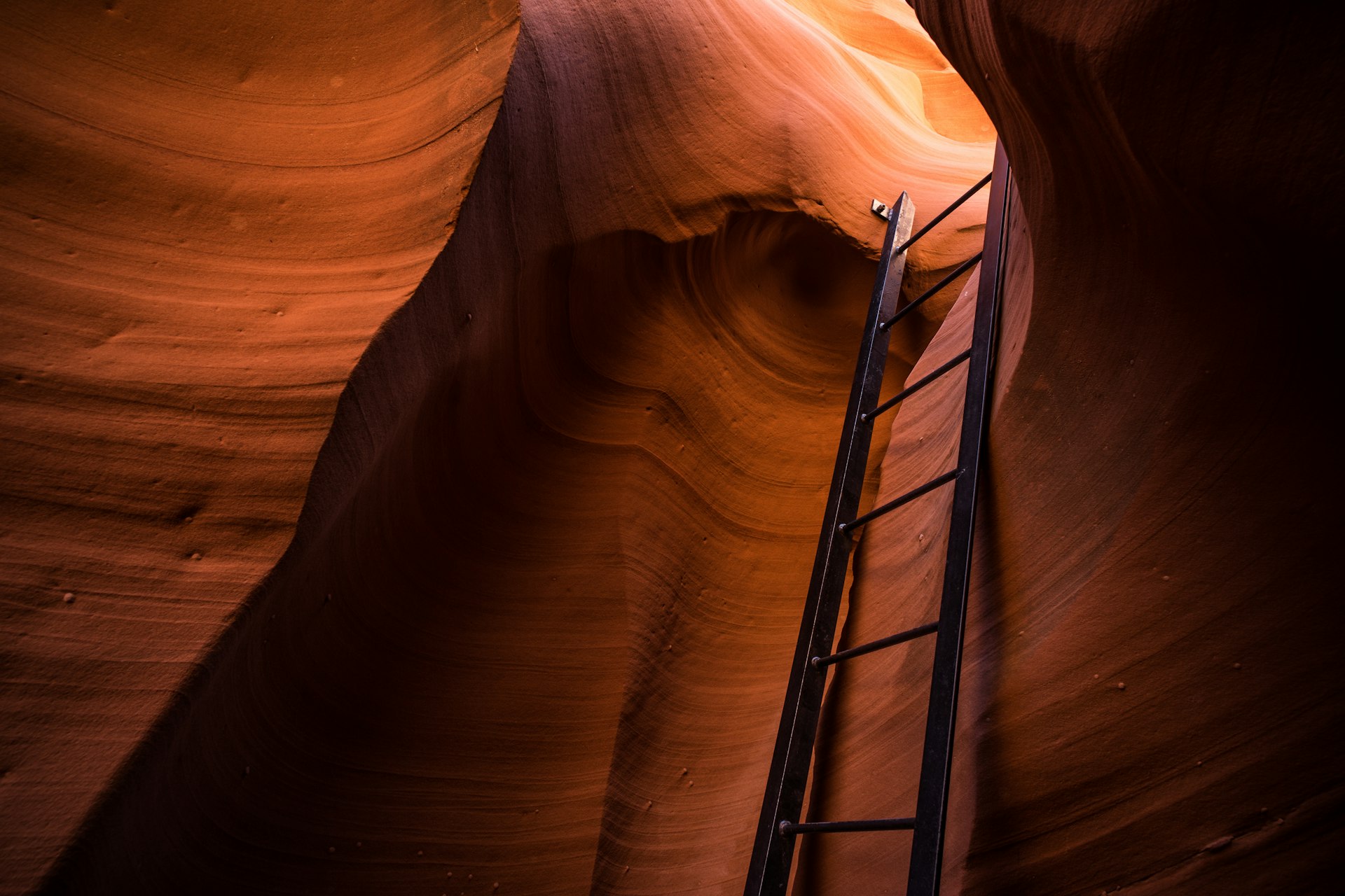 a ladder going through a slot in a canyon